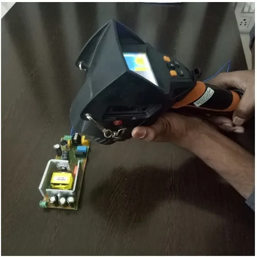 Engineer checking an LED driver board with a thermal camera